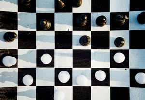 A photo of a chess board in black and white with a game in progress. 